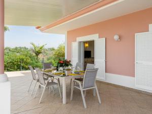 a dining room with a table and chairs on a patio at Villa Villa Pescada by Interhome in Albufeira