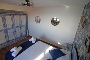 a bedroom with a bed with blue and white sheets at LA MAR SALADA in Lastres