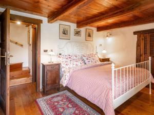 a bedroom with a white bed and a wooden ceiling at Holiday Home Maison Meynet by Interhome in Sarre