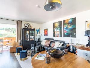 a living room with a couch and a table at Apartment Les Patios-7 by Interhome in Saint-Tropez