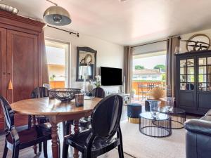 a living room with a wooden table and chairs at Apartment Les Patios-7 by Interhome in Saint-Tropez