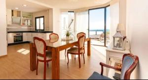 a kitchen and dining room with a table and chairs at Villa Torre Paraíso in Torrox