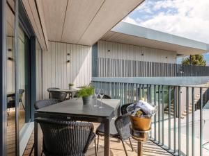 a patio with a table and chairs on a balcony at Apartment Emma Deluxe Aparthotel-14 by Interhome in Fürth
