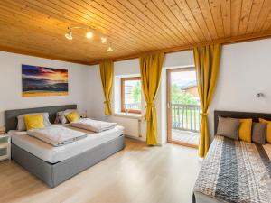 two beds in a room with windows at Holiday Home Marion by Interhome in Saalfelden am Steinernen Meer