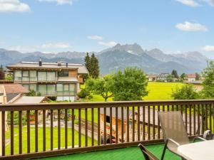 a balcony with a view of a house and mountains at Holiday Home Marion by Interhome in Saalfelden am Steinernen Meer +45 photos