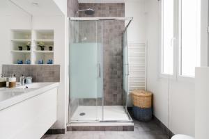 a bathroom with a shower and a sink at Edgar Suites Marais - Réaumur in Paris