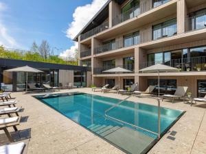 a swimming pool in front of a building at Apartment Emma Deluxe Aparthotel-5 by Interhome in Fürth