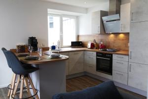 a kitchen with a counter and a table in it at Ferienwohnung Wiehl - Bielstein in Wiehl