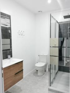 a bathroom with a toilet and a glass shower at Le temps d'une pause''' 