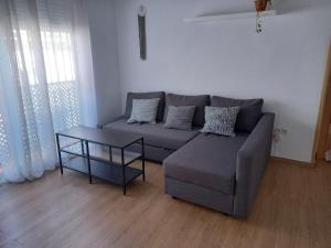 a living room with a couch and a table at El Viajero en Sevilla in Seville