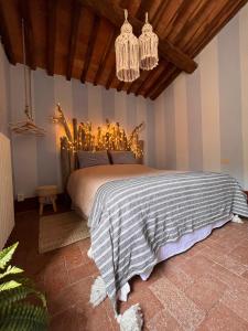 A bed or beds in a room at Borgo Al Canto Degli Alberi