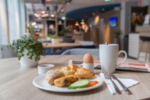 a plate of croissants and eggs on a table at Holiday Inn Express Brussels-Grand-Place, an IHG Hotel in Brussels