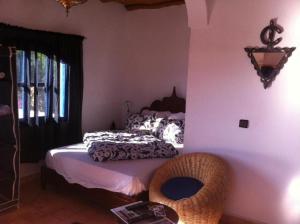 a bedroom with a bed and a window at Room in Guest room - Room in villa Lair De La Mer in Sidi Kaouki