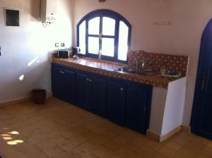a kitchen with a sink and a window at Room in Guest room - Room in villa Lair De La Mer in Sidi Kaouki