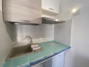 a kitchen with a sink and a counter top at Villette di Cala Creta in Lampedusa