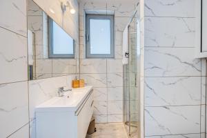 a bathroom with a sink and a mirror at PROFIL Family House in Pogorzelica +29 photos