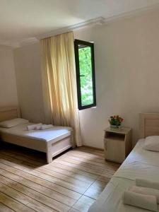 a bedroom with two beds and a window at Apartment Sairme in Sairme