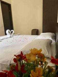 a bed with a swan towel and flowers on it at Apartment Sairme in Sairme