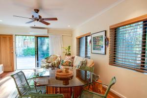 a living room with a glass table and chairs at Tropical Boho Nightcliff Casinha 3BR 1.5BR in Nightcliff