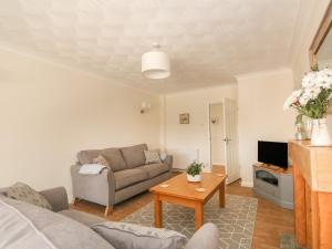 a living room with a couch and a table at Sea Point in Skegness