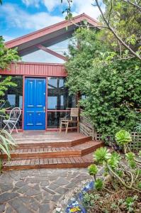 a house with a blue door and a patio at Beachview Bungalow Warrnambool in Warrnambool