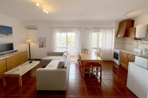 a living room with a couch and a table at Praia do Vau by amcf in Portimão