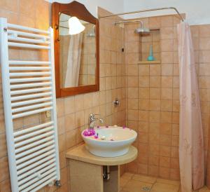 a bathroom with a sink and a shower at Trulli Vulés in Ostuni +44 photos