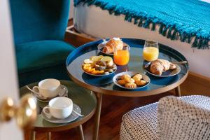 a tray of breakfast foods and drinks on a table at Pavean Suites Frattaminore in Frattaminore