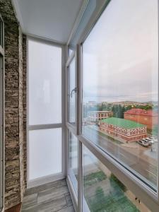 a large window with a view of a building at 2x SuperLUX Arbat Chehova-Kirova 55 in Ustʼ-Kamenogorsk