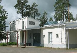 Ilmajoki的住宿－Etelä-Pohjanmaan Opisto，上面有旗帜的白色建筑