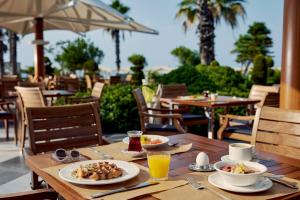 a wooden table with two plates of food on it at TUI MAGIC LIFE Belek in Belek