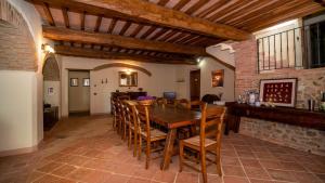a large dining room with a wooden table and chairs at Podere Cerciano in Radicondoli