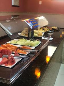 a buffet line with different types of food on plates at Hotel Real Jequie in Jequié