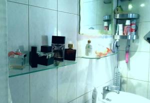 a bathroom with a glass shelf above a sink at LOBBY comfort studio in Thessaloniki +18 photos
