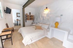 a bedroom with a bed and a table with a lamp at La Finquita - Adeje in Adeje