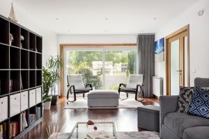 a living room with a couch and chairs at JOIVY Sleek House Balcony & 2 Terraces in Porto in Maia