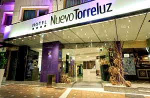 a store front of a hotel with a purple facade at Nuevo Torreluz in Almería