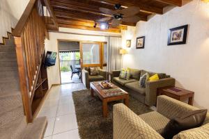 a living room with couches and a table at Legend Safaris 257B - in Kruger Park Lodge in Hazyview