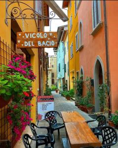 an alley with a wooden table and chairs on a street at La Poventa in Tuoro sul Trasimeno