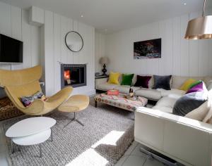 a living room with a couch and a fireplace at Black Rock House in Padstow