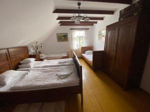a bedroom with two beds and a dresser in it at Sioło Budy in Budy