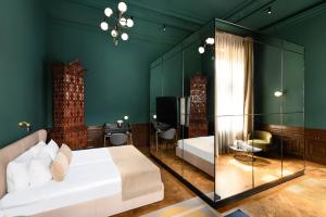 a bedroom with a bed and a glass wall at Hotel Oktogon Haggenmacher by Continental Group in Budapest +116 photos
