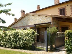 a house with a gate and a fence at La Loggina Maxi in Tuoro sul Trasimeno