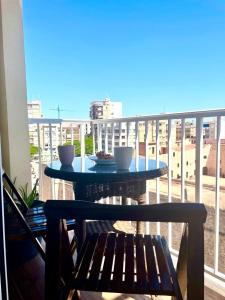 einen Tisch auf einem Balkon mit zwei Tassen drauf in der Unterkunft Central loft apartments in Santa Pola