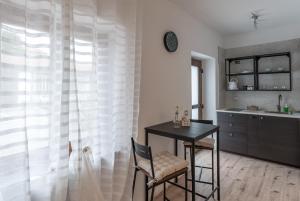a kitchen with a table and a desk and a sink at La corte di Silvia CENTRO in Sesto Calende