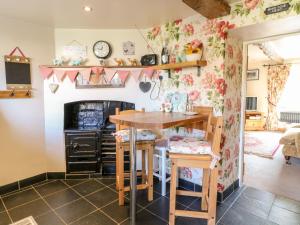 a kitchen with a wooden table and a dining room at The Cottage in Lincoln
