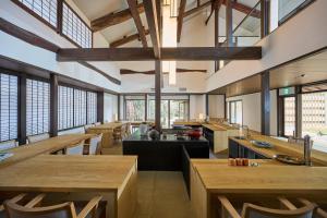 a large dining room with wooden tables and windows at Azumi Setoda in Onomichi