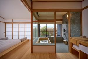 a bedroom with a tub in the middle of a room at Azumi Setoda in Onomichi