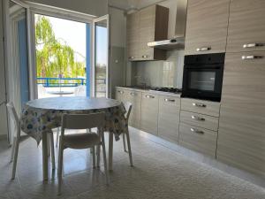 a kitchen with a table with chairs and a television at Campitur in Campomarino