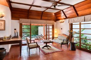 a living room with a couch and a table at Evolve Back Coorg in Siddapur